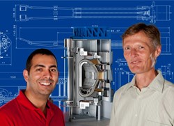 Dr. Olaf Neubauer (right) and David Castaño Bardawil (left) in front of a cross-section model of the ITER fusion reactor. Source: Forschungszentrum Jülich (Click to view larger version...)